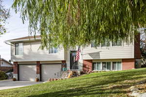 View of front facade with a garage and a front lawn