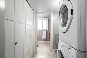 Washroom featuring stacked washer / dryer