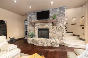 Living room with a fireplace and dark hardwood / wood-style floors