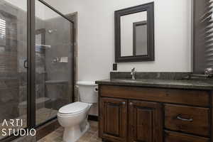 Bathroom featuring vanity, toilet, and walk in shower