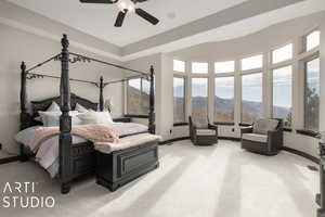 Carpeted bedroom featuring a mountain view and ceiling fan