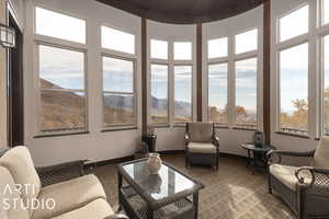 Sunroom / solarium featuring a mountain view, wood ceiling, and a wealth of natural light