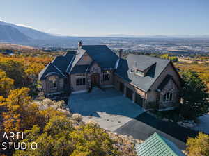 View of front of property with a mountain view and a garage