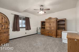 Bedroom with ceiling fan and light carpet