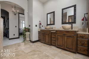 Bathroom featuring vanity and an inviting chandelier