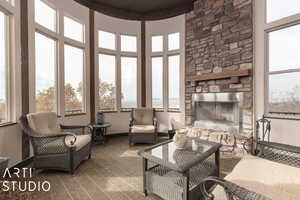 Sunroom / solarium featuring a fireplace and wooden ceiling