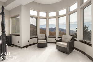 Sunroom featuring a mountain view