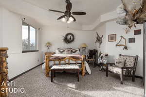 Carpeted bedroom with ceiling fan