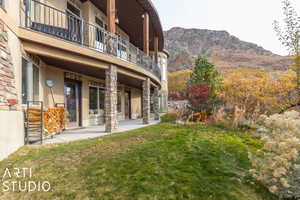 Exterior space with a mountain view, a patio area, and a balcony