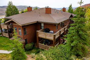 Rear view of house featuring a mountain view