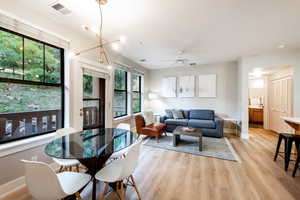 Dining room with light hardwood / wood-style floors and ceiling fan