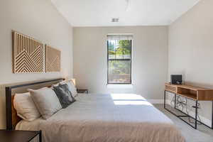 Carpeted bedroom with ceiling fan