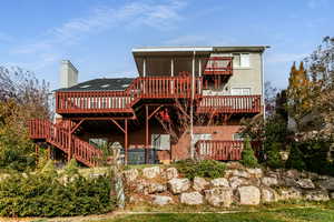 Rear view of house featuring multiple decks.