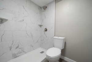 Bathroom with toilet and tiled shower