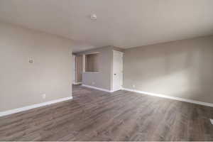 Spare room featuring dark hardwood / wood-style floors