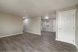 Unfurnished room featuring dark hardwood / wood-style floors