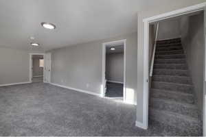 Staircase featuring carpet floors