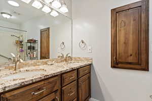 Bathroom featuring decorative backsplash, vanity, and a textured ceiling