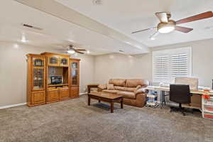 Living room with ceiling fan and carpet floors