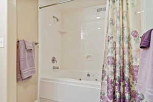 Bathroom featuring shower / bath combination with curtain