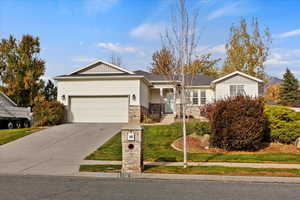 Single story home featuring a front lawn and a garage