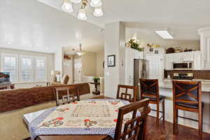 Dining space with lofted ceiling and a textured ceiling