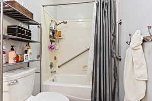 Bathroom with shower / bath combo and toilet