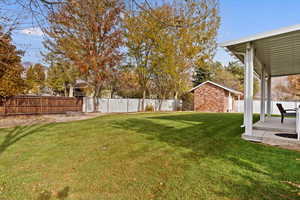 View of yard featuring a patio area and a storage shed