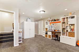 Interior space featuring carpet and a textured ceiling