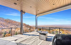 Deck featuring a mountain view and a fire pit