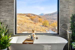 Stand alone tub featuring gorgeous mountain views