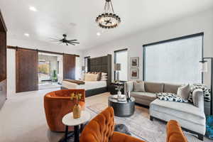 Master Bedroom Suite with sitting room featuring light carpet, a barn door to the Bathroom