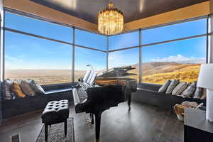 Sunroom with a mountain view and an inviting chandelier