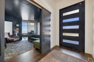 Foyer entrance featuring dark hardwood flooring