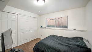 Carpeted bedroom featuring a closet