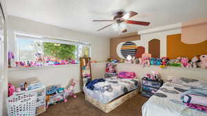 Bedroom featuring dark carpet and ceiling fan