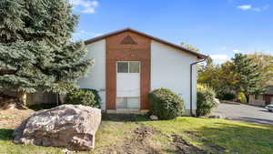 View of side of property featuring a lawn