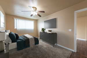 Bedroom with ceiling fan and dark hardwood / wood-style floors