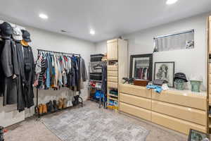 Walk in closet featuring light carpet