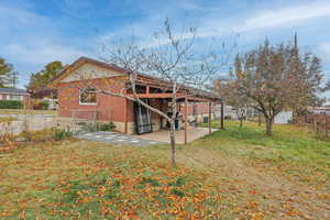 Rear view of property featuring a yard and a patio