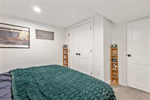 Carpeted bedroom featuring a closet