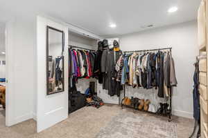 Walk in closet with carpet flooring