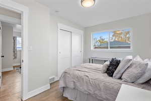 Bedroom featuring light hardwood / wood-style floors and a closet