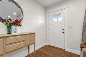 Foyer entrance with dark hardwood / wood-style floors