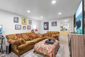 Living room with light colored carpet and a textured ceiling