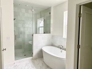 Bathroom featuring separate shower and tub