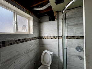 Bathroom featuring toilet and an enclosed shower