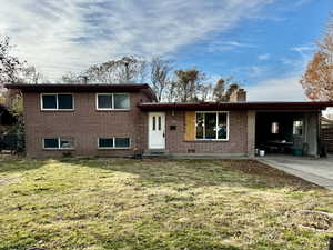 Split level home with a carport and a front yard