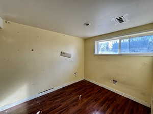 Empty room featuring hardwood / wood-style flooring