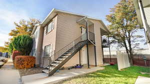 View of property exterior featuring a lawn